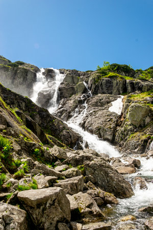 Mountain landscape with waterfall in Tatra Mountains, Poland. The largest waterfall in Poland, Wielka Siklawa. The world of beauty.の写真素材