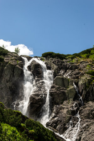 Mountain landscape with waterfall in Tatra Mountains, Poland. The largest waterfall in Poland, Wielka Siklawa. The world of beauty.の写真素材