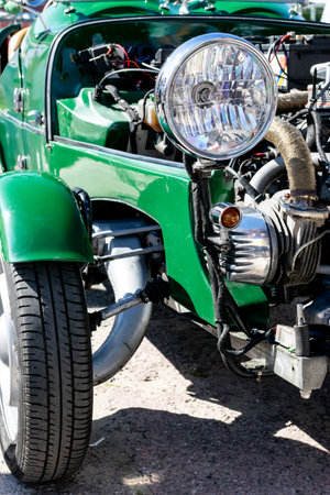 Detail of the headlight and radiator of an old classic car. Old car and its interior.の写真素材