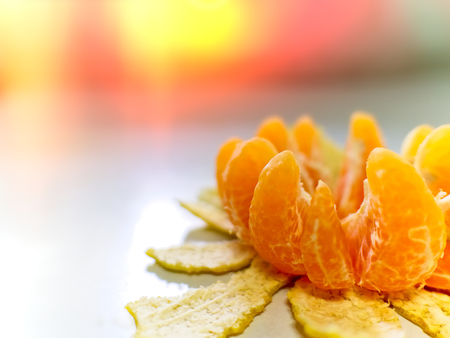 peel orange or tangerine fruit lotus sharp on right background with red lightの写真素材