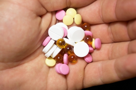 Handful of tablets in a palmの写真素材