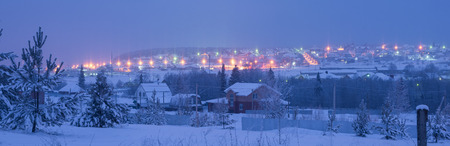 View at dusk on the road with lights and settlementの写真素材