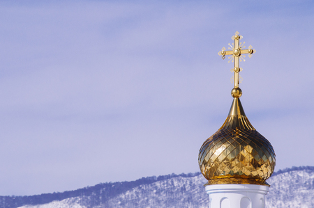 Church with golden dome in the winter forestの写真素材