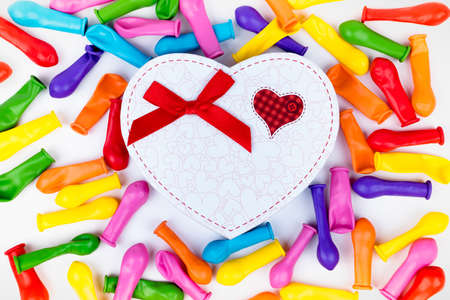 colorful balloons in heart gift box. white backgroundの写真素材