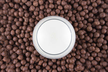 Breakfast in a glass of milk over muesliの写真素材