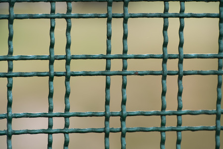 Green metallic grill on brown backgroundの写真素材