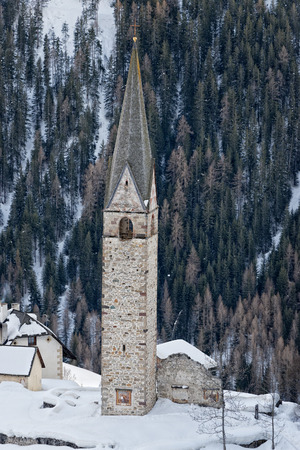mountain church in winter on sunny dayの写真素材