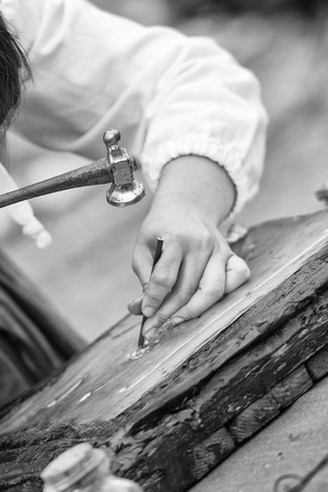 hands while engraving copper with an hammerの写真素材