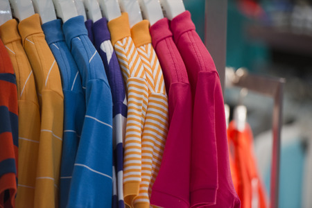 different colors polo shirt on display stand