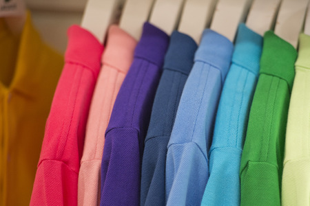different colors polo shirt on display stand