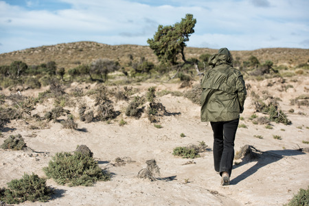 young girl walking on ocean beach sand dunesの写真素材