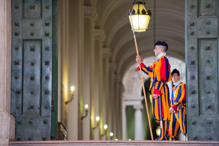 VATICAN CITY, ITALY - MARCH 1, 2014 : A member of the Pontifical Swiss Guard, Vatican in San Pietro...