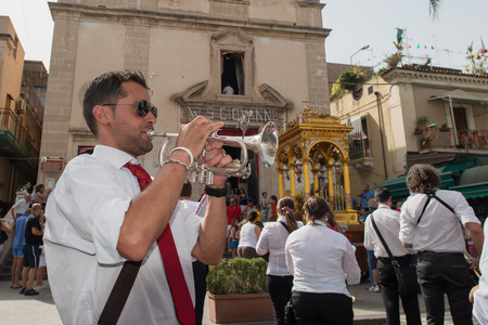 ACI TREZZA, ITALY - JUNE, 24 2014 - San Giovanni traditional parade with "pisci a mari" show where they reproduce tuna hunt. Tuna is roled by a young man who finally escape from fishermenのeditorial素材