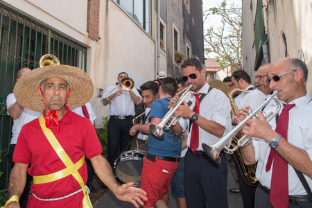 ACI TREZZA, ITALY - JUNE, 24 2014 - San Giovanni traditional parade with "pisci a mari" show where they reproduce tuna hunt. Tuna is roled by a young man who finally escape from fishermenのeditorial素材