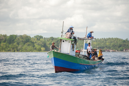 BUNAKEN, INDONESIA - APRIL, 5 2014 - fishing ship returning to fisherman village in Sulawesi Islandのeditorial素材