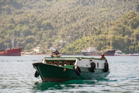 BUNAKEN, INDONESIA - APRIL, 5 2014 - fishing ship returning to fisherman village in Sulawesi Islandのeditorial素材