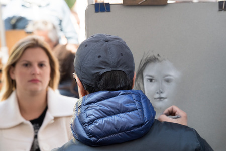 PARIS, FRANCE - MAY 1 2016 - Artist painting and drawing portraits on sunny sunday day in Montmartre Place du Tertre famous artist retreatのeditorial素材