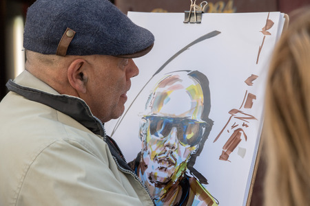PARIS, FRANCE - MAY 1 2016 - Artist painting and drawing portraits on sunny sunday day in Montmartre Place du Tertre famous artist retreatのeditorial素材