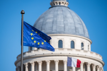 Paris Pantheon capitol dome with french and europe waving flagの写真素材