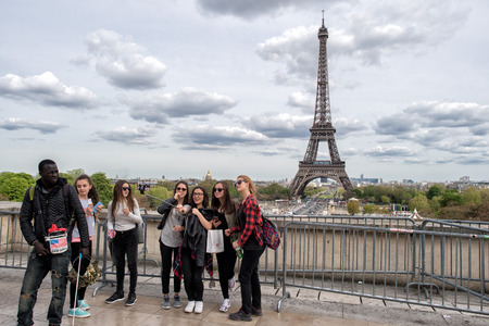 PARIS, FRANCE - MAY 2, 2016: Tour Eiffel town symbol on sunny day, not a lot of tourist after november terrorist attack, they are taking pictures and selfies using cellular phonesのeditorial素材