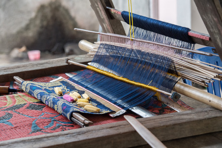 woman hand working at loom in Indonesia