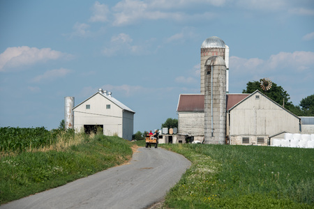 grain wheat metallic silo on cloudy sky background with farmの写真素材