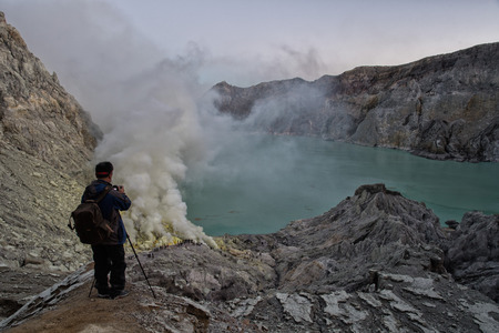 JAVA, INDONESIA - AUGUST, 9, 2016 - Miners are carrying sulfur from Ijen Volcano Blue flames at night, more than 100 kilos each one for a cheap salaryのeditorial素材