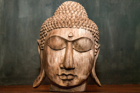 gautama buddha head closed eyes wooden sculpture statue detailの写真素材
