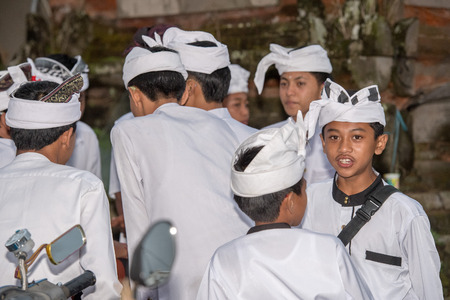 BALI, INDONESIA - AUGUST 13, 2016 - Balinese monk and worshipper with traditional ritual dress and hat at the temple for full moon celebrationのeditorial素材