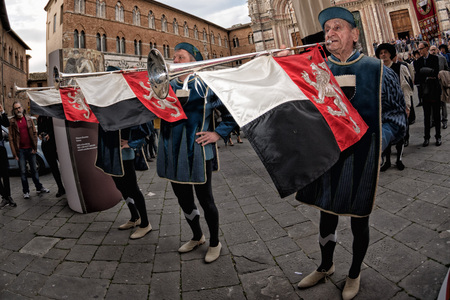 SIENA, ITALY - MARCH 25 2017 - Traditional flag wavers parade. 17 district of medieval town on...