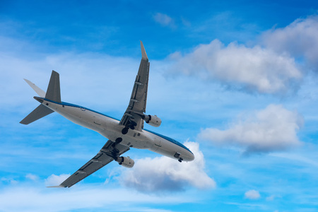 Airplane Jet while landing off on the blue cloudy scky background