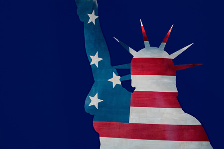 Statue of liberty silhouette on usa star and stripes flag background