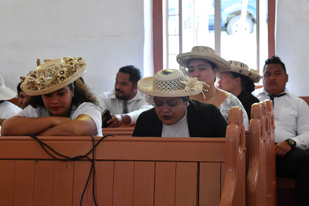 AITUTAKI, COOK ISLAND - AUGUST, 27 2017 - Local people at the christian mass wearing traditional colorful polynesian dressのeditorial素材