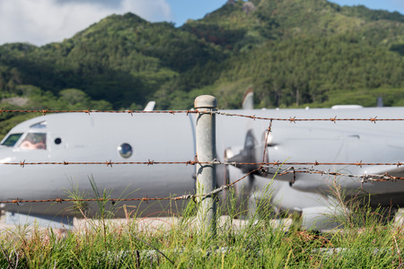 military aircraft detail behind barbed wireの写真素材
