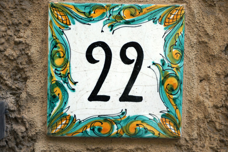 Ceramic number 22 tile on italian old houseの写真素材
