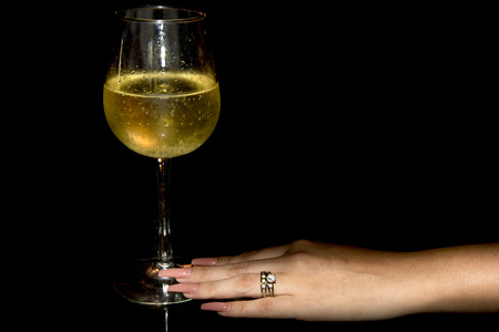 female hand holding champagne glass detailの写真素材