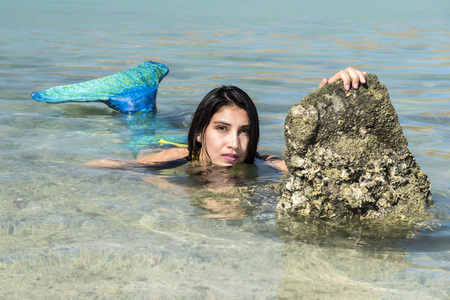 beautiful Black hair Mermaid portrait on sandy beach and looking at youの写真素材