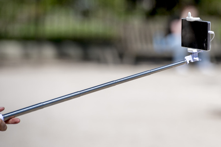 Selfie using remote control and extension tripodの写真素材