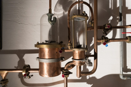 Copper still alembic inside distillery to distill grapes and produce spirits 