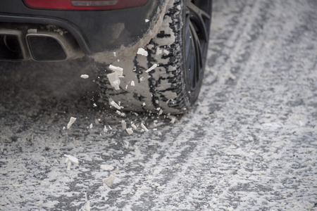 car winter snow tire detail while turningの写真素材