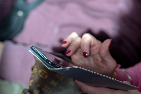 Hands while texting on cellular smartphone detailの写真素材