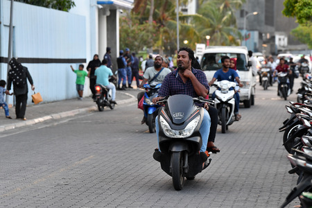 MALE, MALDIVES - FEBRUARY 17 2018 - People in the street before evening pray time in male maldives...