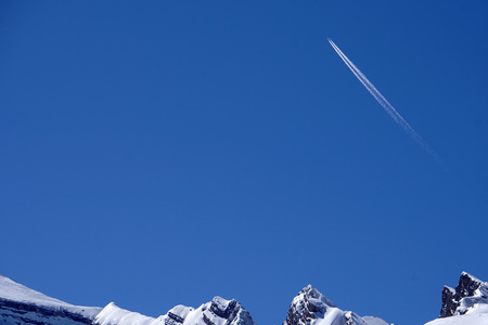 Jet Airplane trails tracks chemtrails in the deep blue sky background