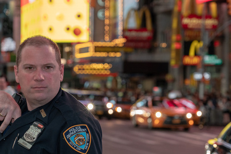 NEW YORK, USA - MAY 25 2018 -  NYPD policeman in Times Square is a major commercial intersection,...