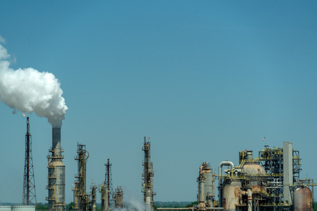 oil refinery on blue sky cloudy background smoking chimneyの写真素材