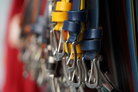 different colors leather belt on display at the market for sale