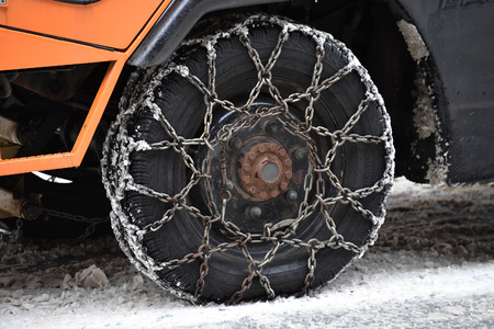 car winter snow tire detail while turning chain