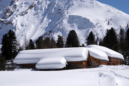 Isolated wood mountain house cabin hut covered by snowの写真素材