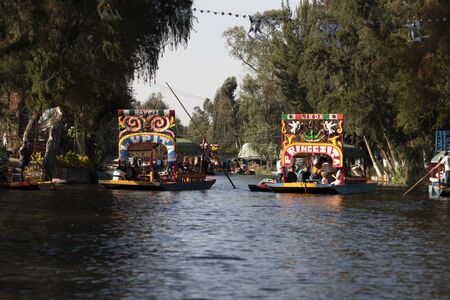 MEXICO CITY, MEXICO - JANUARY 30 2019 - Xochimilco the mexican little venice attract tourists and other city residents to ride on colorful gondola-like boats around the 170 km of canalsのeditorial素材