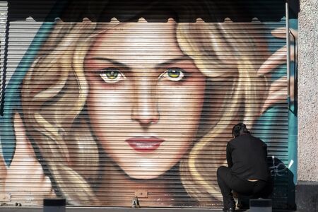 MEXICO CITY, MEXICO - JANUARY 30 2019 - All the shops rolli down gates have graffiti in 20 november business street. Art is all over the capital, and is especially visible before the stores openのeditorial素材